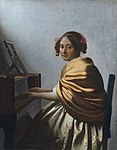 En ung kvinna som sitter vid en cembalo, attribuerad till Johannes Vermeer 1670–72