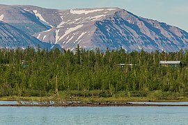 Mountains near Norilsk, at the northwest end of the Putorana Plateau. Notice the wooded taiga in the foreground, near the lake and at lower elevation, in contrast to the treeless tundra landscape in the mountains in the background.