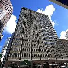 A high rise building with signs reading "First Republic Bank" on the ground floor