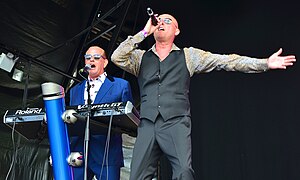 Heaven 17 performing live in 2014 Left to right: Martyn Ware (keyboards), Glenn Gregory (vocals)