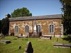 A simpled small church with a bellcote on the left gable