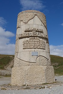 A cylindrical stone monument with an inscription inside an outline of France