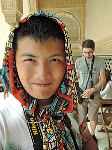 A Chinese man with headscarf in his fashion costume