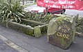 An old horse trough and a welcome sign at the junction with Grane Road.