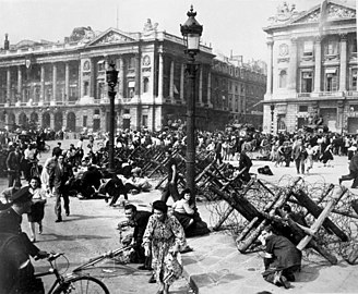 Crowds celebrating the liberation of Paris scatter from German sniper fire August 1944