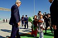 John Kerry approaches two children bearing a traditional greeting of bread and salt as he arrives at Ashgabat International Airport in Ashgabat, Turkmenistan, on November 3, 2015