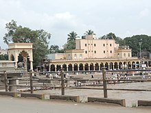 Large building, with steps down to a river