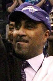 Lorenzo Romar, celebrating the Washington Huskies' 2011 Pac-10 tournament championship