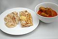 Roti kosong (left) and roti telur (centre) with a side order of chicken curry