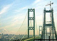 Tacoma Narrows Bridge eastbound span from the Kitsap Peninsula during construction in February 2007, with Tacoma and Mount Rainier visible in the background.