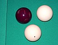 Image 9A set of standard carom billiard balls, comprising a red object ball, one plain white cue ball, and one dotted white cue ball (replaced in modern three-cushion billiards by a yellow ball) for the opponent (from Carom billiards)