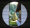 Shōji is a door, window or room divider consisting of translucent paper over a frame of wood which holds together a lattice of wood or bamboo.