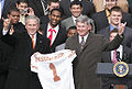 George W. Bush and Mack Brown give the Hook 'em Horns in front of the White House after Texas won the 2005 National Championship in American college football.