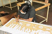 Craftswoman brush painting with wax in Kandy, Sri Lanka. Note the large cover area of the wax