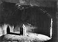 Inside the cave, with votive Jain stele.