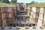 A view of the stepwell with several decorated pillars