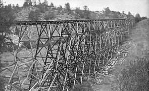 A tall V-flume trestle around 1900.