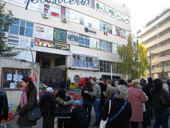 People mourning victims in front of the factory