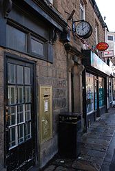 Disley post office, Cheshire, showing the gold large wall box for the 2012 Olympic Games.