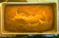 A loaf of banana bread sitting in a loaf pan