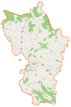 Mapa konturowa powiatu kaliskiego, po prawej znajduje się punkt z opisem „Koźminek”