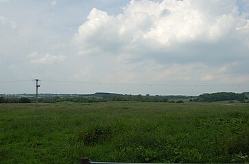 The field to the north of Saint Peter's Church, the site of the domestic buildings of the Priory. There are two large parallel dug out earthworks in the middle of the field which putatively form the remains of a moated convent.[7]