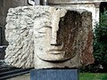 Archangel Michael by Emily Young in the grounds of St Pancras New Church. Plaque inscription: "In memory of the victims of the 7th July 2005 bombings and all victims of violence. 'I will lift up my eyes unto the hills'"