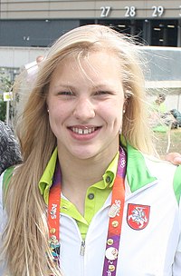 head-and-shoulders photo of smiling blond teenage woman