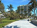 Lummus Park boardwalk near 14th Street and Ocean Drive, showing downed trees and sand strewn across walkway (originally more sand, removed a day earlier), view north