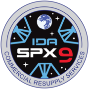 NASA's SpX-9 mission patch graphic simulates the view from inside IDA-2, displaying the three petals of the docking adapter.