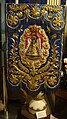 An embroidered processional banner or gonfalon on display in the museum.