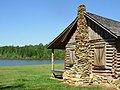 A relocated log cabin stands on the grounds of SUSCC.