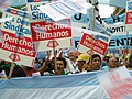 Image 28Union members march in Argentina on Human Rights Day in December 2005. The signs read "Worker rights are human rights..