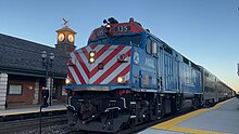 Metra 135, a rebuilt EMD F40PH-3, idles at Barrington, Illinois