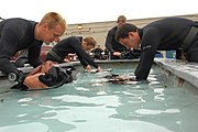 Second Phase Students do a safety check on their gear before making a dive.