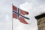 En norsk örlogsflagga hissad på Fredrikstens fästning.