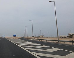 Turn off to Madinat Al Kaaban on Al Shamal Road