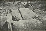 Black-and-white photograph of a tomb being excavated.