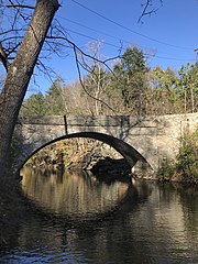 Portrait photo depicting the Valley Green bridge over the Wissahickon creek. Taken during the fall