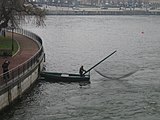 A small rowboat with an attached lift net in Norrström, Stockholm, Sweden