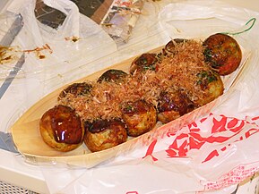 Takoyaki is a ball-shaped Japanese snack made of a wheat flour-based batter and typically filled with minced or diced octopus.