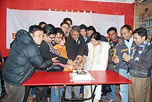 group cutting a cake