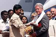 Dark-haired man giving gifts to grey-haired man