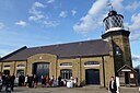 ☎∈ Bow Creek Lighthouse, a warehouse and a shed exhibiting Michael Faraday's work at Trinity Buoy Wharf, London in September 2012.