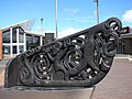 Northern Memorial Square waka sculpture, with the New Lynn War Memorial Library in background.