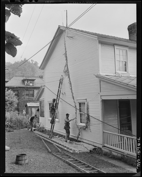 File:Company employed carpenters and painters work on company owned houses. The houses, streets, community buildings show... - NARA - 540869.tif