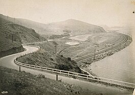 View north from Sierra Point from approximately 1915, showing the Bayshore Highway crossing over Tunnel 5 of the Bayshore Cutoff. The Cutoff is the rail line along the western shoreline of San Francisco Bay.
