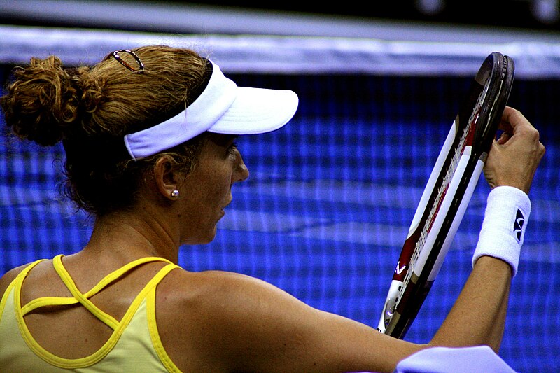 File:Monica Adjusting Her Racket Strings.jpg