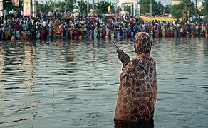 A woman praying during Chhath