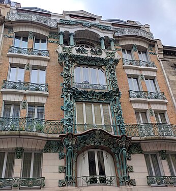 An Art Deco balcony in front of a downtown Paris, France house